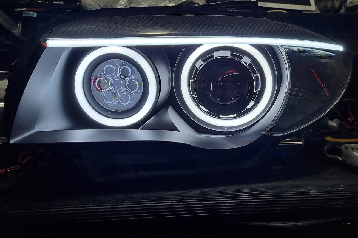 BMW 1 Series E87 & E81 E82 E88 (Pre LCI Halogen) Custom Headlights. Equipped With The Following Options: KYCS Round Angel Eyes (White) | BavGruppe Design Carbon Fibre Eyebrow With LED Strip (White) | Bi-LED Projector | LED High Beam Array