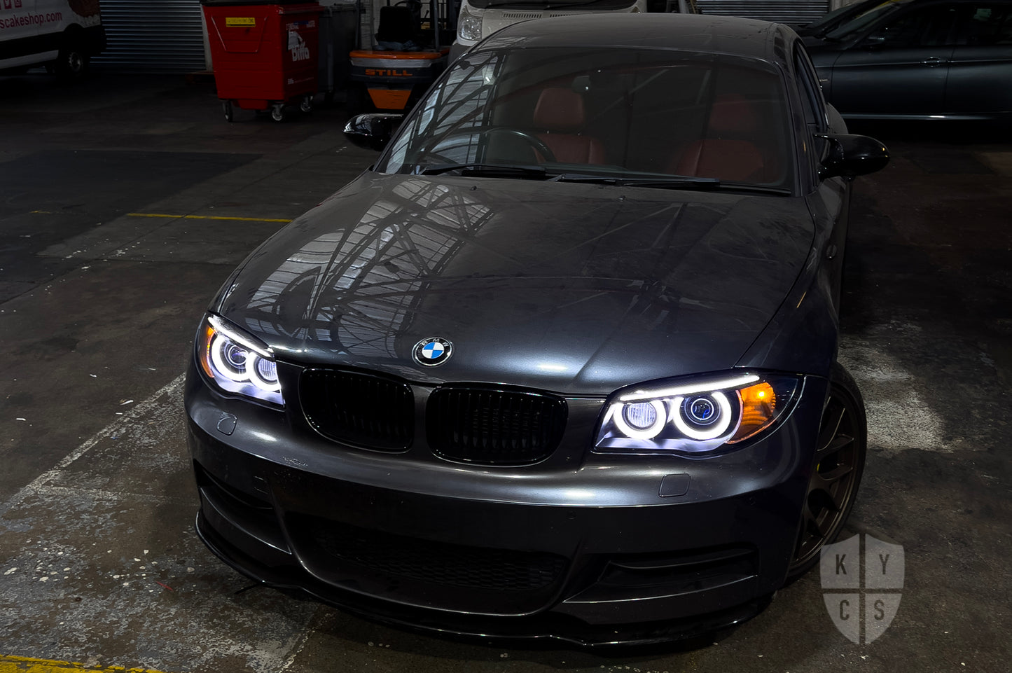 BMW 1 Series E87 & E81 E82 E88 (Pre LCI Xenon/Adaptive Xenon) Custom Headlights. Equipped With The Following Options: BavGruppe Design Round Angel Eyes (White) | BavGruppe Design Carbon Fibre Eyebrow With Optic & LED Strip (White) | G5-BRT Projector & Brackets (Projector Upgrade) | New Headlight Lenses
