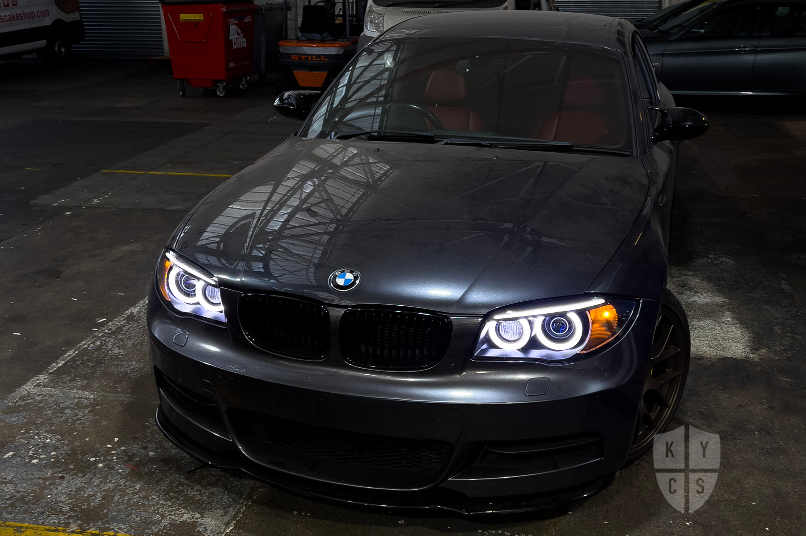 BMW 1 Series E87 & E81 E82 E88 (Pre LCI Xenon/Adaptive Xenon) Custom Headlights. Equipped With The Following Options: BavGruppe Design Round Angel Eyes (White) | BavGruppe Design Carbon Fibre Eyebrow With Optic & LED Strip (White) | G5-BRT Projector & Brackets (Projector Upgrade) | New Headlight Lenses