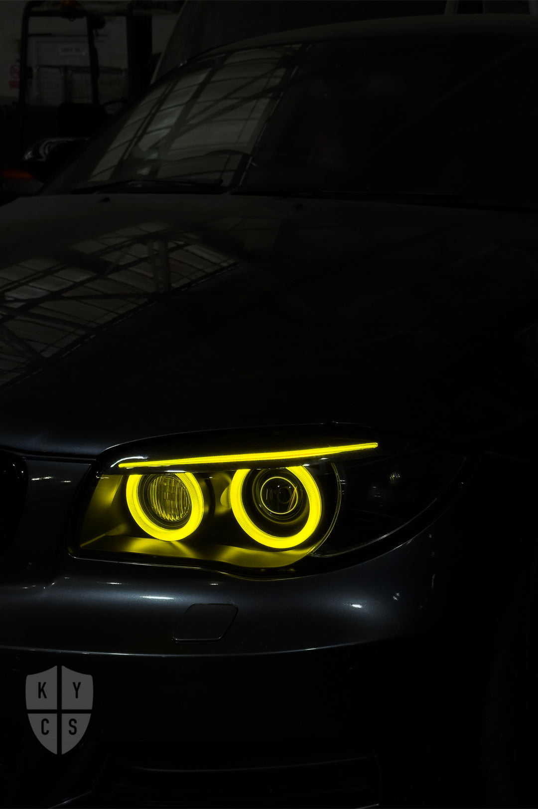 BMW 1 Series E87 & E81 E82 E88 (Pre LCI Xenon/Adaptive Xenon) Custom Headlights. Equipped With The Following Options: BavGruppe Design Round Angel Eyes (Dual Colour - White & CSL Yellow) | BavGruppe Design Carbon Fibre Eyebrow With Optic & LED Strip (Dual Colour - White & CSL Yellow) | G5-BRT Projector & Brackets (Projector Upgrade) | New Headlight Lenses