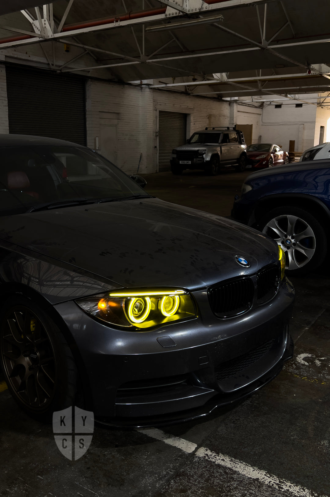 BMW 1 Series E87 & E81 E82 E88 (Pre LCI Xenon/Adaptive Xenon) Custom Headlights. Equipped With The Following Options: BavGruppe Design Round Angel Eyes (Dual Colour - White & CSL Yellow) | BavGruppe Design Carbon Fibre Eyebrow With Optic & LED Strip (Dual Colour - White & CSL Yellow) | G5-BRT Projector & Brackets (Projector Upgrade) | New Headlight Lenses