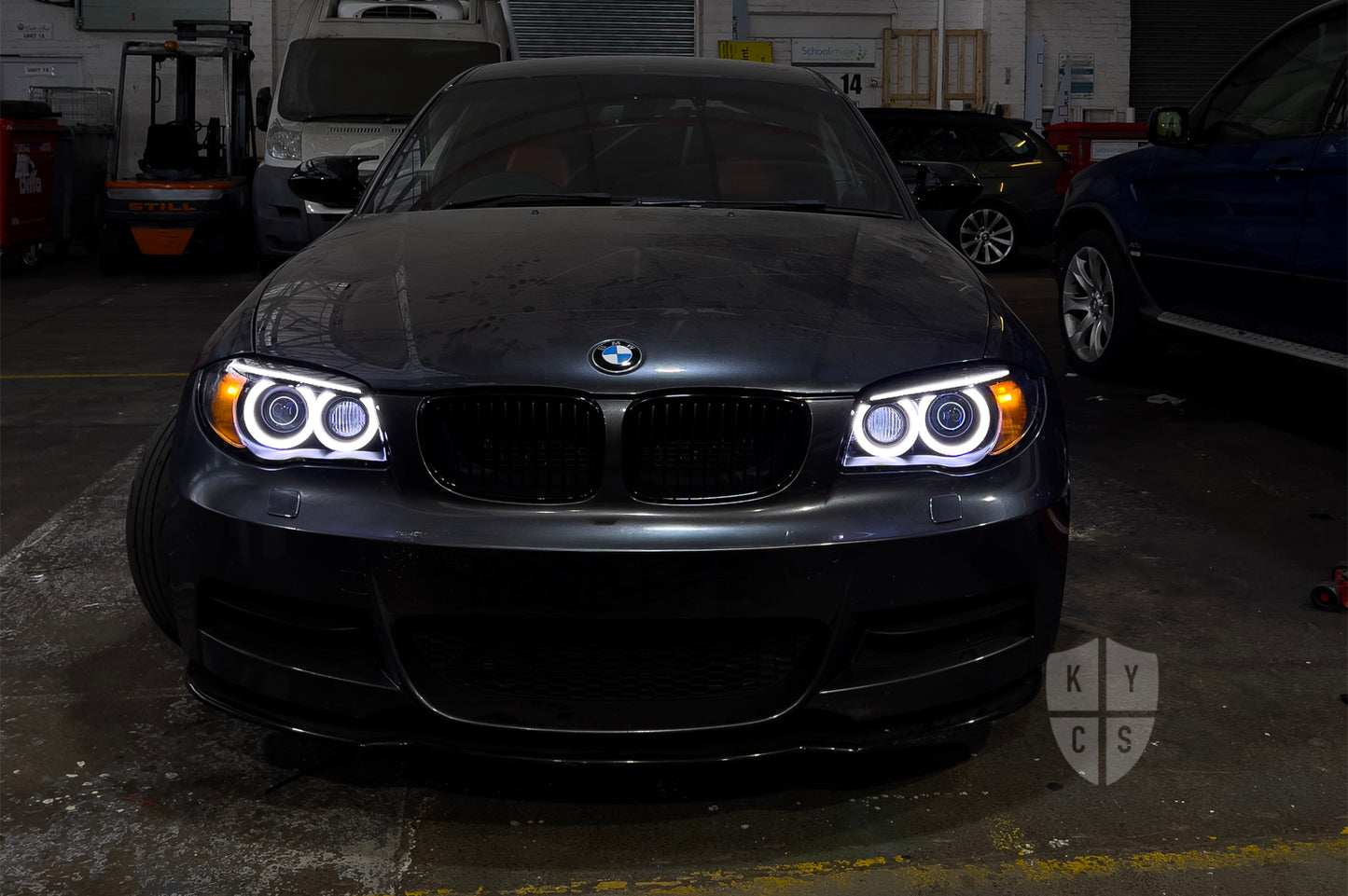 BMW 1 Series E87 & E81 E82 E88 (Pre LCI Xenon/Adaptive Xenon) Custom Headlights. Equipped With The Following Options: BavGruppe Design Round Angel Eyes (White) | BavGruppe Design Carbon Fibre Eyebrow With Optic & LED Strip (White) | G5-BRT Projector & Brackets (Projector Upgrade) | New Headlight Lenses