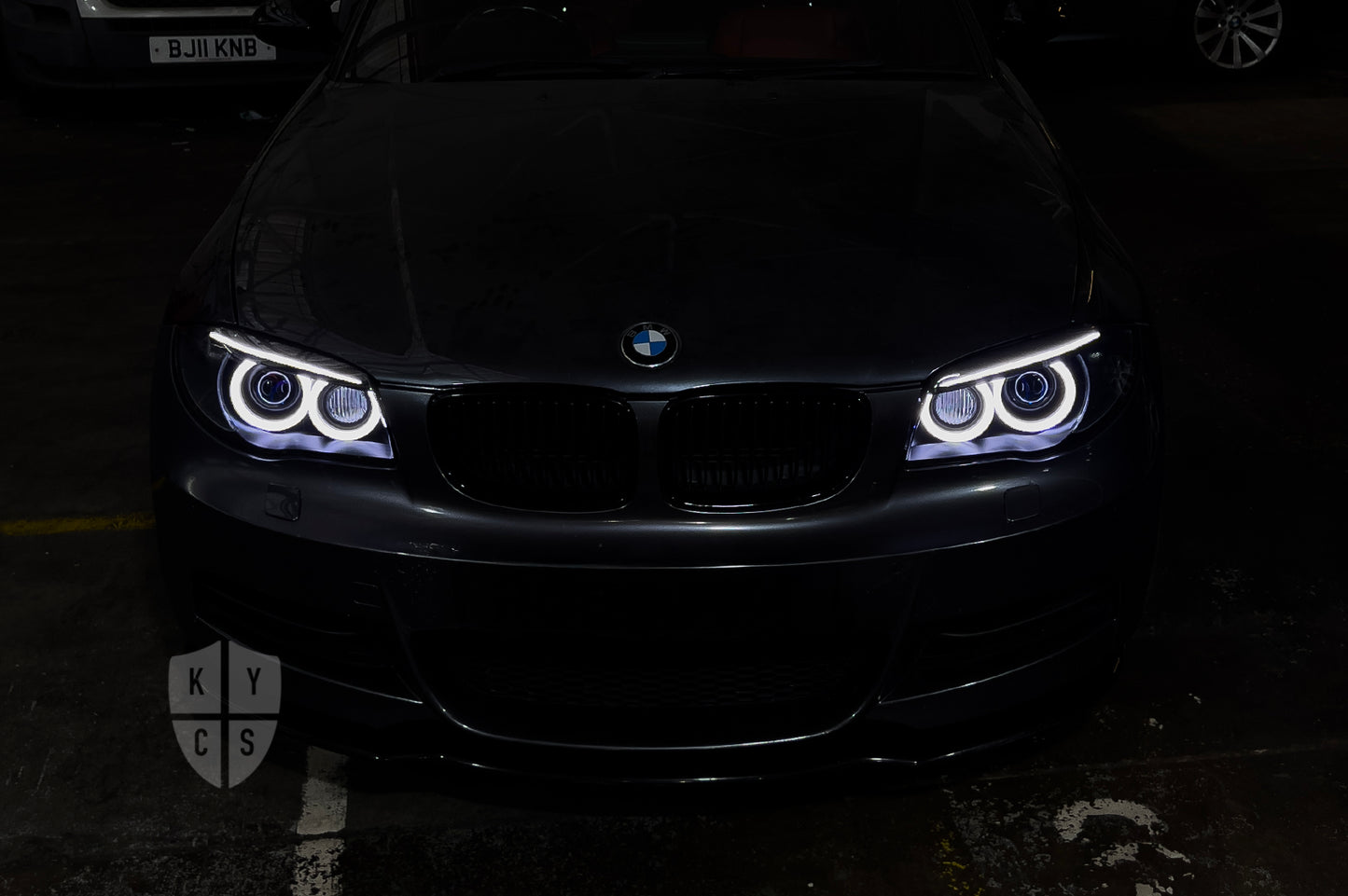 BMW 1 Series E87 & E81 E82 E88 (Pre LCI Xenon/Adaptive Xenon) Custom Headlights. Equipped With The Following Options: BavGruppe Design Round Angel Eyes (White) | BavGruppe Design Carbon Fibre Eyebrow With Optic & LED Strip (White) | G5-BRT Projector & Brackets (Projector Upgrade) | New Headlight Lenses