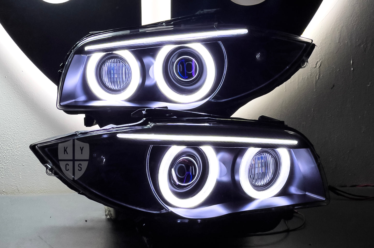 BMW 1 Series E87 & E81 E82 E88 (Pre LCI Xenon/Adaptive Xenon) Custom Headlights. Equipped With The Following Options: BavGruppe Design Round Angel Eyes (White) | BavGruppe Design Carbon Fibre Eyebrow With Optic & LED Strip (White) | G5-BRT Projector & Brackets (Projector Upgrade) | New Headlight Lenses