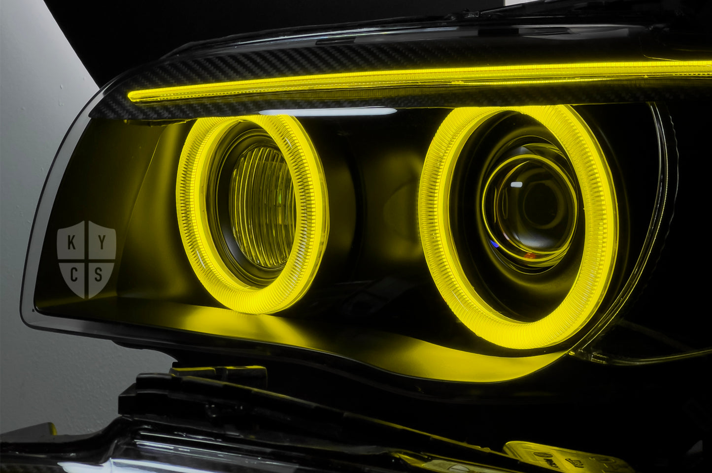 BMW 1 Series E87 & E81 E82 E88 (Pre LCI Xenon/Adaptive Xenon) Custom Headlights. Equipped With The Following Options: BavGruppe Design Round Angel Eyes (Dual Colour - White & CSL Yellow) | BavGruppe Design Carbon Fibre Eyebrow With Optic & LED Strip (Dual Colour - White & CSL Yellow) | G5-BRT Projector & Brackets (Projector Upgrade) | New Headlight Lenses