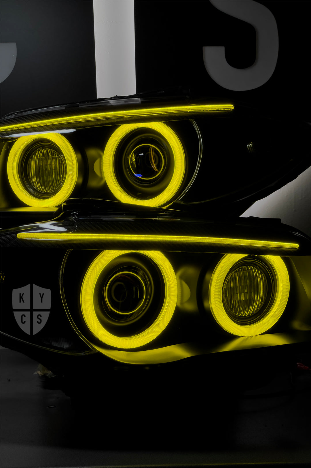 BMW 1 Series E87 & E81 E82 E88 (Pre LCI Xenon/Adaptive Xenon) Custom Headlights. Equipped With The Following Options: BavGruppe Design Round Angel Eyes (Dual Colour - White & CSL Yellow) | BavGruppe Design Carbon Fibre Eyebrow With Optic & LED Strip (Dual Colour - White & CSL Yellow) | G5-BRT Projector & Brackets (Projector Upgrade) | New Headlight Lenses