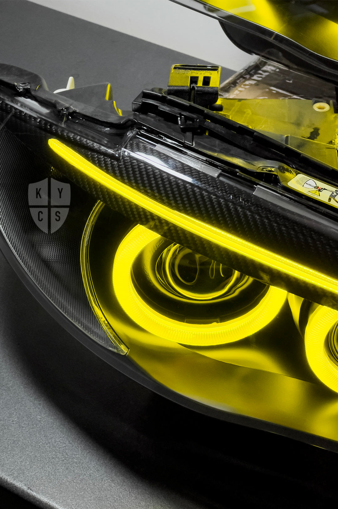 BMW 1 Series E87 & E81 E82 E88 (Pre LCI Xenon/Adaptive Xenon) Custom Headlights. Equipped With The Following Options: BavGruppe Design Round Angel Eyes (Dual Colour - White & CSL Yellow) | BavGruppe Design Carbon Fibre Eyebrow With Optic & LED Strip (Dual Colour - White & CSL Yellow) | G5-BRT Projector & Brackets (Projector Upgrade) | New Headlight Lenses