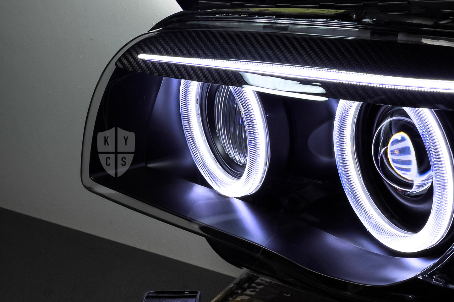 BMW 1 Series E87 & E81 E82 E88 (Pre LCI Xenon/Adaptive Xenon) Custom Headlights. Equipped With The Following Options: BavGruppe Design Round Angel Eyes (White) | BavGruppe Design Carbon Fibre Eyebrow With Optic & LED Strip (White) | G5-BRT Projector & Brackets (Projector Upgrade) | New Headlight Lenses