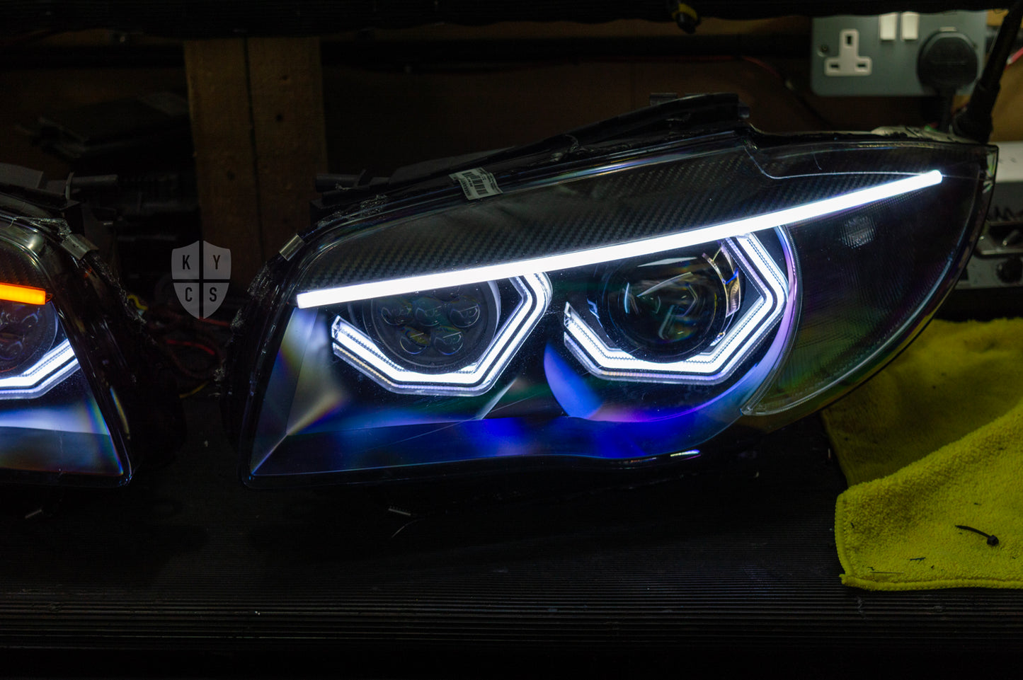BMW 1 Series E87 & E81 E82 E88 (Pre LCI Halogen) Custom Headlights. Equipped With The Following Options: BavGruppe Design Vision Angel Eyes (White) | BavGruppe Design Carbon Fibre Eyebrow With LED Strip (White) | Bi-LED Projector | LED High Beam Array | New Headlight Lenses
