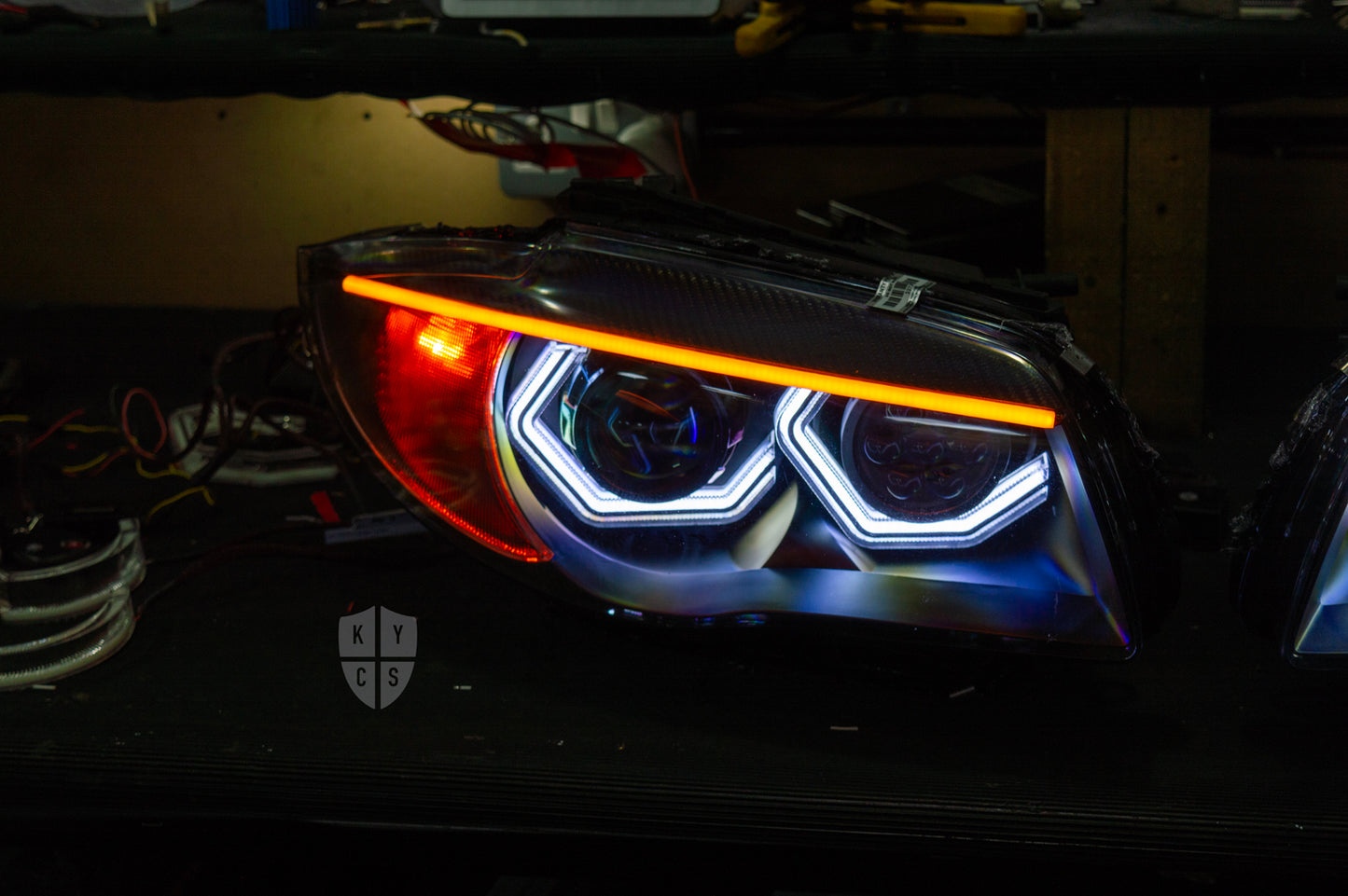 BMW 1 Series E87 & E81 E82 E88 (Pre LCI Halogen) Custom Headlights. Equipped With The Following Options: BavGruppe Design Vision Angel Eyes (White) | BavGruppe Design Carbon Fibre Eyebrow With LED Strip (Switchback) | Bi-LED Projector | LED High Beam Array | New Headlight Lenses