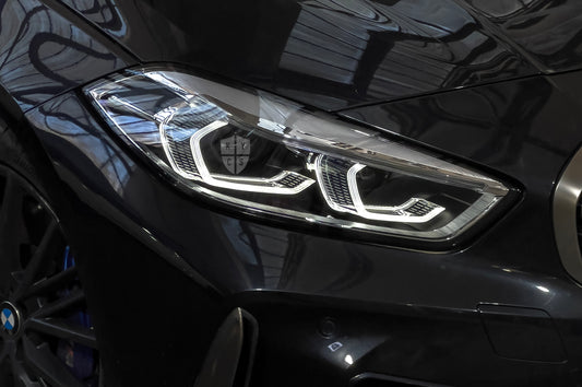 BMW 1 Series F40 LED headlight with the DRL lit, front three-quarter view on the car after a KYCS headlight repair