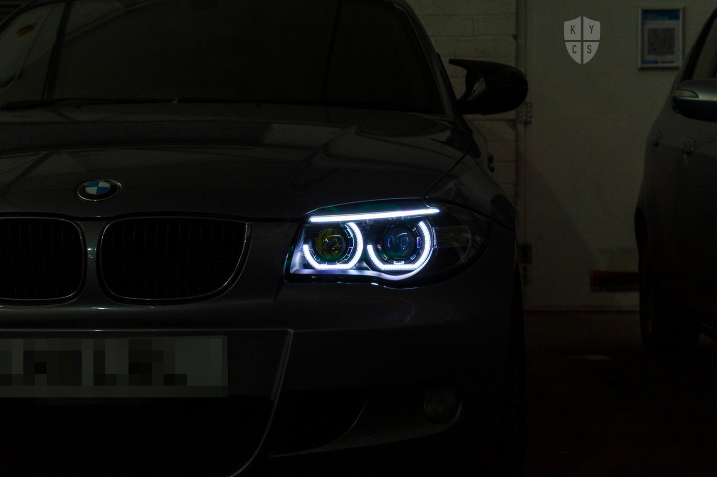 BMW 1 Series E81 E82 E88 (LCI Halogen) Custom Headlights. Equipped With The Following Options: KYCS 3/4 DTM Angel Eyes (White) | BavGruppe Design LED Strip Eyebrow Within OEM Opening (White) | Bi-LED Projector | LED High Beam Projector | New Headlight Lenses
