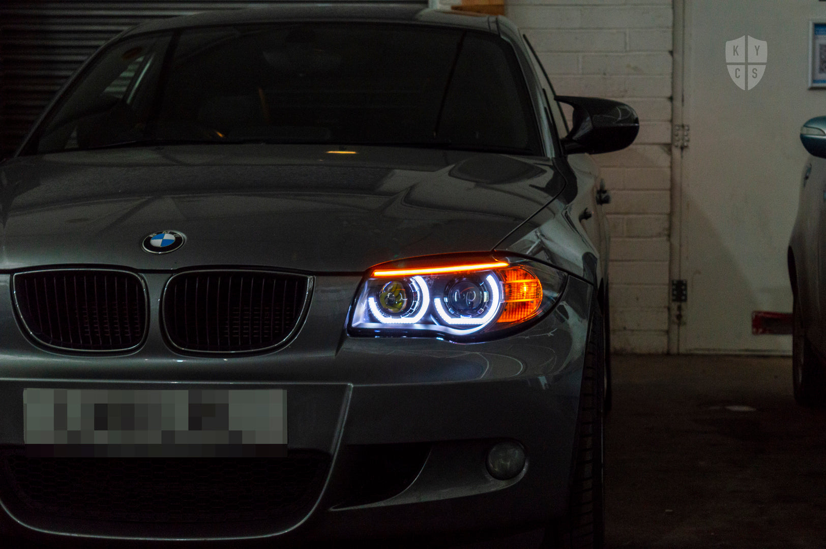 BMW 1 Series E81 E82 E88 (LCI Halogen) Custom Headlights. Equipped With The Following Options: KYCS 3/4 DTM Angel Eyes (White) | BavGruppe Design LED Strip Eyebrow Within OEM Opening (Switchback) | Bi-LED Projector | LED High Beam Projector | New Headlight Lenses