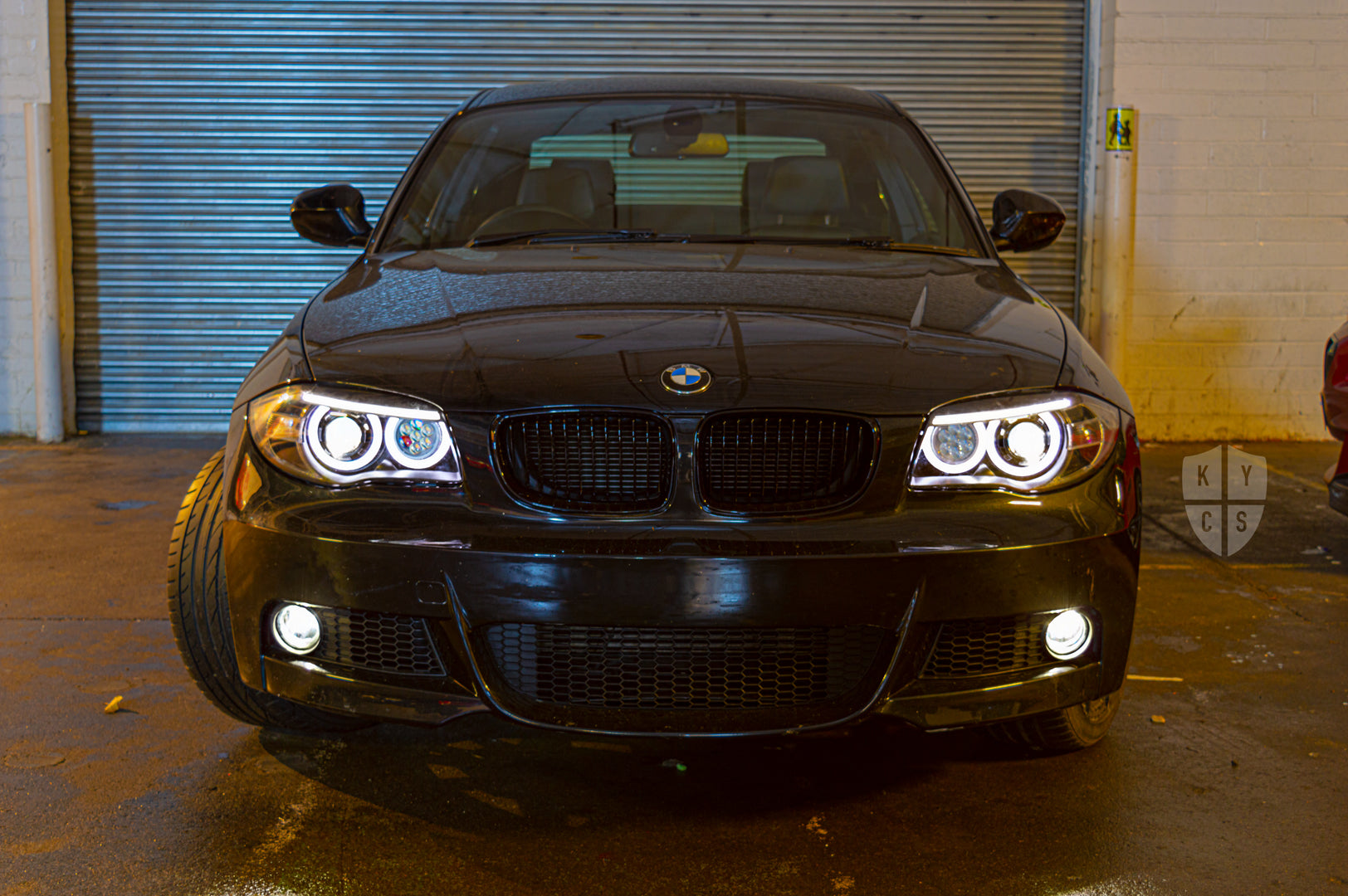 BMW 1 Series E81 E82 E88 (LCI Halogen) Custom Headlights. Equipped With The Following Options: BavGruppe Design Round Angel Eyes (White) | BavGruppe Design LED Strip Eyebrow Within OEM Opening (White) | Bi-LED Projector | LED High Beam Array | New Headlight Lenses
